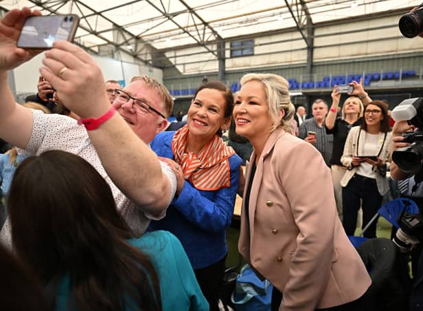 <p>Sinn Fein northern leader, Michelle O’Neill (R) and Mary Lou McDonald, Sinn Fein leader (C) pose for photos with candidates and activists (Photo: Getty Images)</p>