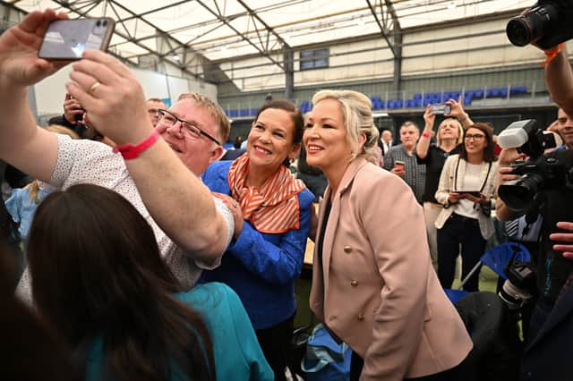 <p>Sinn Fein northern leader, Michelle O’Neill (R) and Mary Lou McDonald, Sinn Fein leader (C) pose for photos with candidates and activists (Photo: Getty Images)</p>