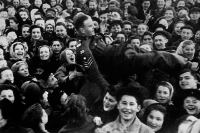 8th May 1945:  A British sergeant is lifted up as Moscow women celebrate VE Day.  (Photo by Keystone/Getty Images)