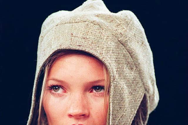 Kate Moss wears a flapped hat with a suede jacket, 07 April 1994, during the showing of the Fall 1994 Anne Klein collection (Photo by TIMOTHY CLARY/AFP via Getty Images)