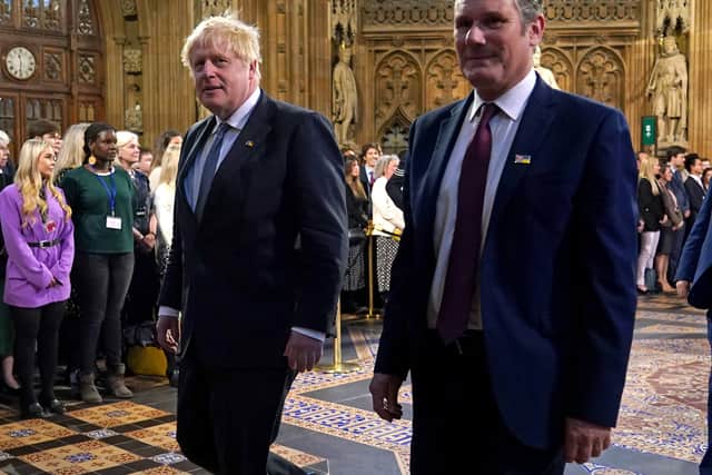 Prime Minister Boris Johnson (left) and the leader of the Labour Party Keir Starmer walk through the Central Lobby at the Palace of Westminster ahead of the State Opening of Parliament in the House of Lords, London. 