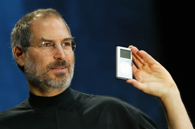 Former Apple CEO Steve Jobs holds a new mini iPod at Macworld January 6, 2004 in San Francisco.