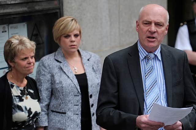 Mother and sister of Milly Dowler, Sally (L) and Gemma (C) listen as father Bob Dowler reads a statement outside the Old Bailey in central London, on June 24, 2011 (Photo by CARL COURT/AFP via Getty Images)
