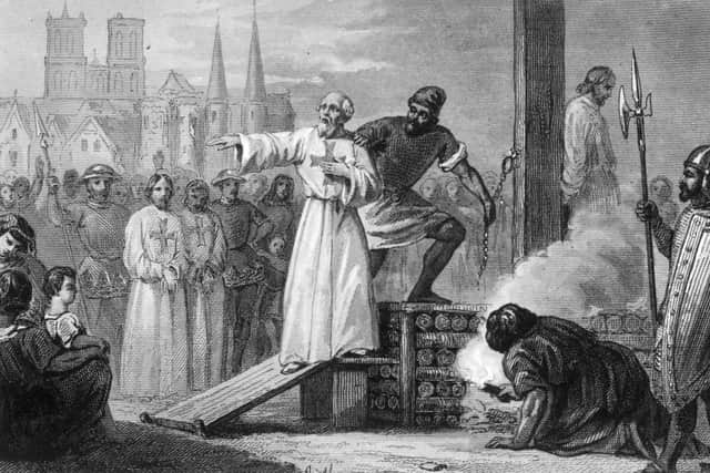 1314, Jacques de Molay (c. 1244 - 1314), the 23rd and Last Grand Master of the Knights Templar, is lead to the stake to burn for heresy. He is shouting to Pope Clement and King Philip that they will face 'a tribunal with God' within a year. They both died soon (Photo by Hulton Archive/Getty Images)