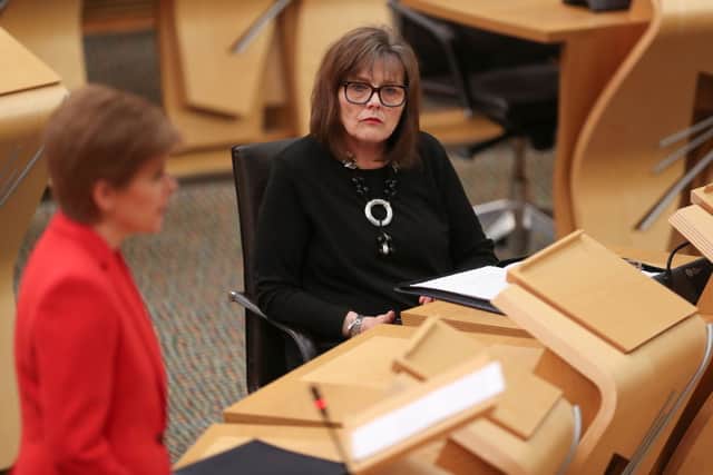 Jeane Freeman listens to First Minister Nicola Sturgeon in the Scottish Parliament in Holyrood, on January 19, 2021 in Edinburgh, Scotland (Photo by Russell Cheyne - Pool/Getty Images)