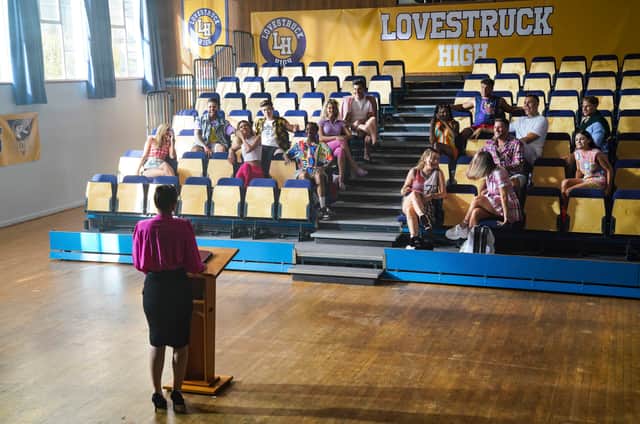 Principal Nelson (Ria Lina) addresses the students in assembly (Pic: Amazon Studios)