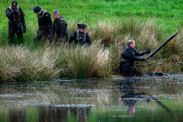 Police search a pond near the former home of Peter Tobin in Bathgate June 4, 2007 in Bathgate, Scotland, as part of the inquiry into Vicky Hamilton’s disappearance.
