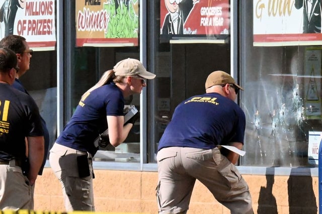 FBI agents look at bullet impacts , the day after a gunman shot dead 10 people (Photo: USMAN KHAN/AFP via Getty Images)