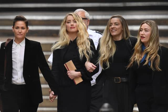 Amber Heard and her sister Whitney at the libel trial in London (Pic: AFP via Getty Images)
