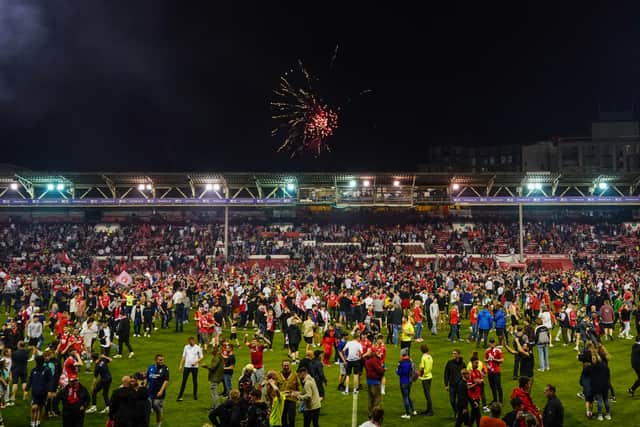  Nottingham Forest fans celebrating on the pitch after they reach the play off final. 