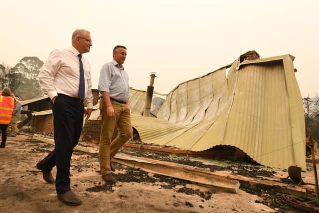 Scott Morrison was heckled when he visited a burnt out village during the 2019 Australia wildfires (image: Getty images)