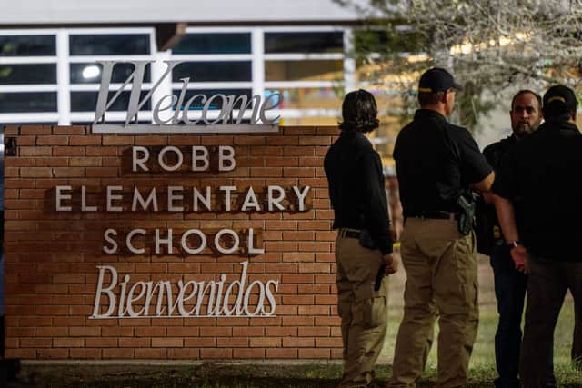 Law enforcement officers speak together outside of Robb Elementary School following the mass shooting at Robb Elementary School on May 24, 2022 in Uvalde, Texas (Photo by Brandon Bell/Getty Images)
