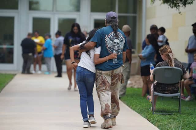 Families gather and hug outside the Willie de Leon Civic Center where grief counseling will be offered in Uvalde, Texas (Photo by ALLISON DINNER/AFP via Getty Images)
