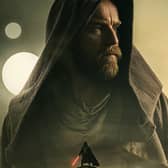 Ewan McGregor as Obi-Wan Kenobi, his hood pulled close to his face, staring to his right (Credit: Lucasfilm)