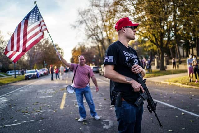 A supporter of Donald Trump keeps a hand on his gun during a ‘Stop the Steal rally’ in 2020 (Photo: KEREM YUCEL/AFP via Getty Images)