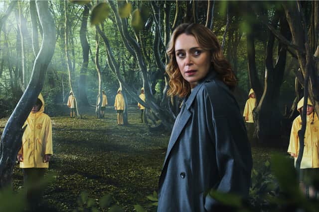 Keeley Hawes surrounded by creepy children in yellow rainjackets in The Midwich Cuckoos  (Credit: Sky)