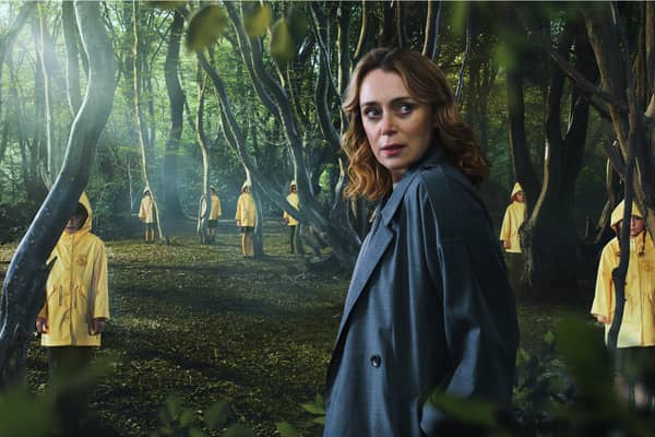 Keeley Hawes surrounded by creepy children in yellow rainjackets in The Midwich Cuckoos  (Credit: Sky)