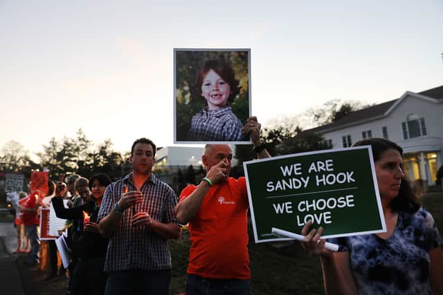 Mark Barden holds up a picture of his son Daniel who was killed in the Sandy Hook massacre  (Pic: Spencer Platt/Getty Images)