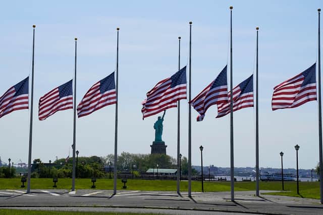 US flags, across New York Bay from the Statue of Liberty, fly at half-mast as a mark of respect to those killed in Uvalde,