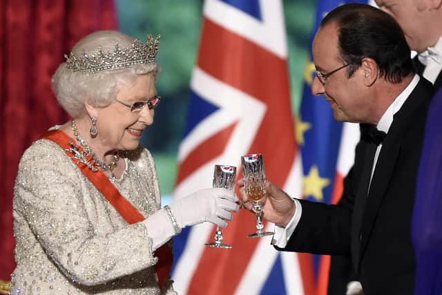 The Queen speaks fluent French. She is pictiured with former French President Francois Hollande.
