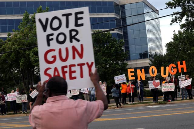 Gun-control advocates hold a vigil outside of the National Rifle Association (NRA) headquarters following the recent mass shooting at Robb Elementary School on May 25, 2022 in Fairfax, Virginia (Photo by Kevin Dietsch/Getty Images)