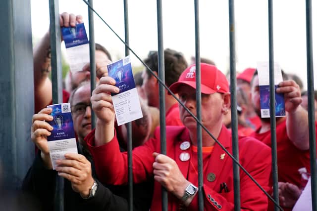 Liverpool fans stuck outside the ground show their match tickets during the UEFA Champions League Final at the Stade de France, Paris (Photo: PA/Adam Davy)