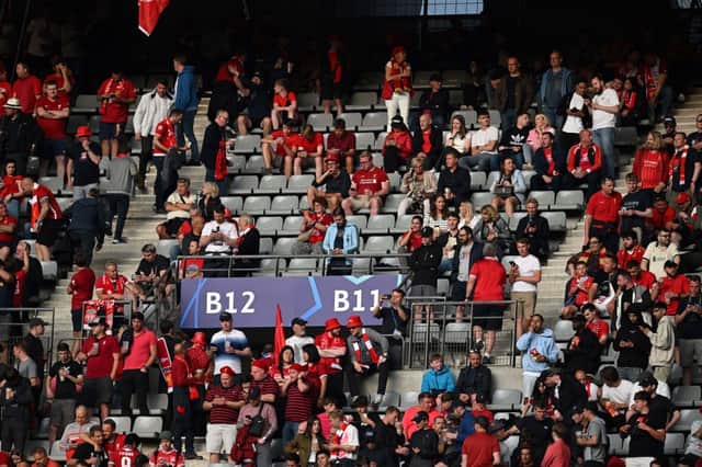 Liverpool’s supporters cheer for their team next to empty seats as they wait for the start of the UEFA Champions League final (Photo by PAUL ELLIS/AFP via Getty Images)