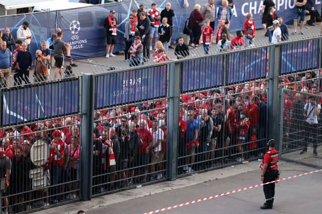 Liverpool fans stand outside unable to get in in time leading to the match being delayed (Photo by THOMAS COEX/AFP via Getty Images)