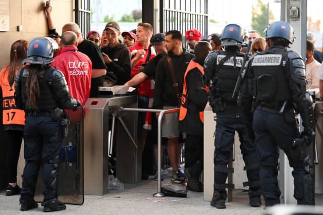 Police and stewards are seen outside the stadium as Liverpool fans queue outside the stadium prior to  the UEFA Champions League final (Photo by Matthias Hangst/Getty Images)