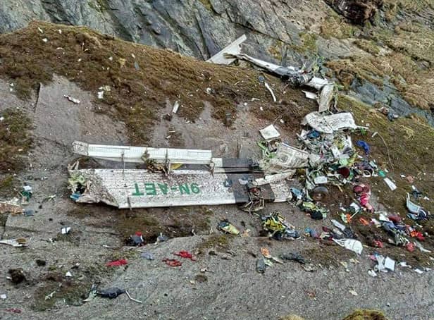 <p>The wreckage of a Twin Otter aircraft, operated by Nepali carrier Tara Air, on a mountainside in Mustang on May 30, 2022 (Photo by BISHAL MAGAR/AFP via Getty Images)</p>