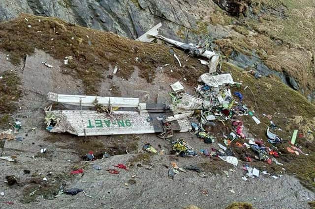 The wreckage of a Twin Otter aircraft, operated by Nepali carrier Tara Air, on a mountainside in Mustang on May 30, 2022 (Photo by BISHAL MAGAR/AFP via Getty Images)