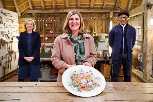 Kirsten Ramsay, Helen Ringland, and Jay Blades at The Repair Shop. Helen Ringland is holding a Jubilee Plate (Credit: BBC/Ricochet)