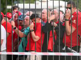  Liverpool fans are seen queuing outside the stadium prior to the UEFA Champions League final. 