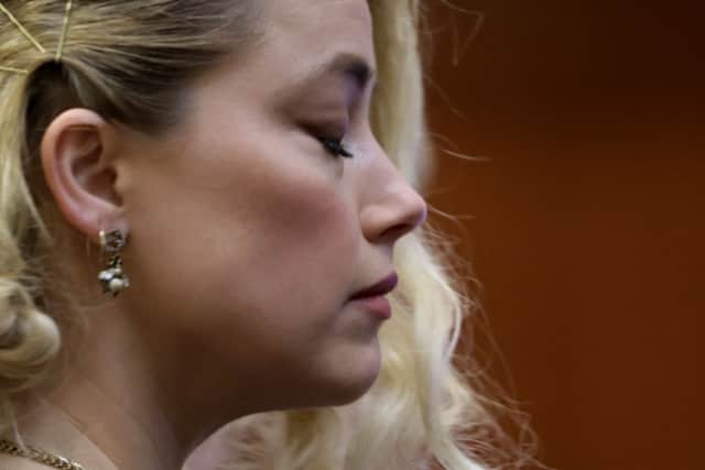 US actress Amber Heard waits before the jury announced a split verdict in favor of both Johnny Depp and Amber Heard on their claim and counter-claim in the Depp v. Heard civil defamation trial at the Fairfax County Circuit Courthouse (Photo by EVELYN HOCKSTEIN/POOL/AFP via Getty Images)