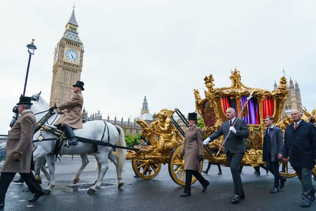 The gold state coach passes the Houses of Parliament during an early morning rehearsal through London ahead of the Platinum Jubilee Pageant