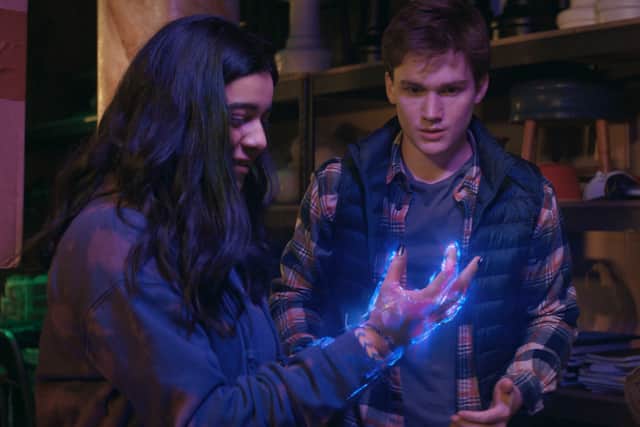 Iman Vellani as Ms. Marvel/Kamala Khan and Matt Lintz as Bruno, looking at Kamala’s glowing hand in awe (Credit: Marvel Studios)