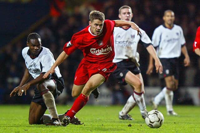 Liverpool’s Michael Owen tries to take the ball past Fulham’s Martin Djetou during the Premier League match at Loftus Road in west London 23 November 2002 (Photo: ADRIAN DENNIS/AFP via Getty Images)