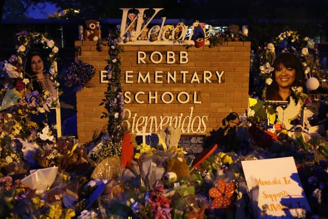 Flowers and photographs are seen at a memorial dedicated to the victims of the mass shooting at Robb Elementary School (Photo by Alex Wong/Getty Images)