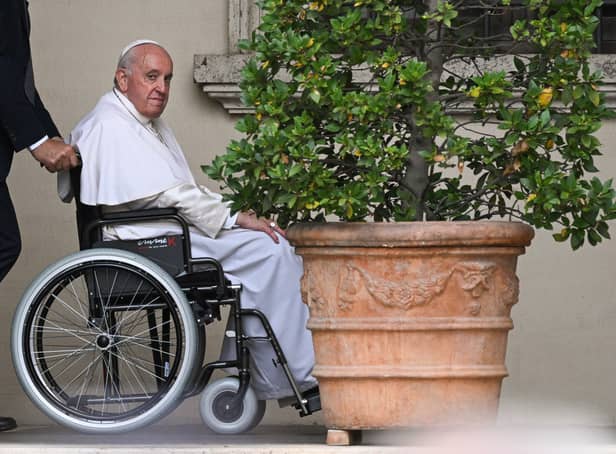 <p>Pope Francis, seated in a wheelchair following knee treatment in June 2022 (Pic: AFP via Getty Images)</p>