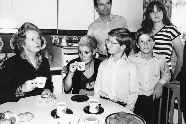 Former Prime Minister Margaret Thatcher drinking tea with the Patterson family in their kitchen (Pic: Getty Images)