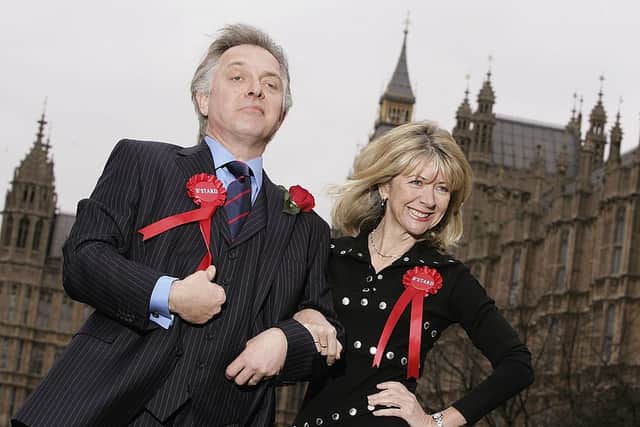 Rik Mayall and Marsha Fitzalan pose as their comic 1980’s TV characters Alan and Sarah B’Stard to launch the four-month UK tour of the stage adaptation of their satirical TV series The New Statesman outside the Houses of Parliament, Millbank on March 20, 2006 in London, England.  (Photo by Gareth Cattermole/Getty Images)