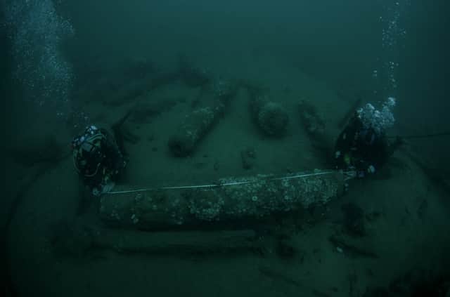 Julian and Lincoln Barnwell measuring a cannon that was found with the wreck of the HMS Gloucester (PA)
