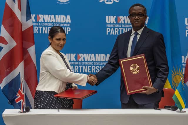 Priti Patel and Rwandan Minister of Foreign Affairs and International Cooperation Vincent Biruta, shake hands after signing an agreement at Kigali Convention Center, Kigali, Rwanda on April 14, 2022 (AFP via Getty Images)