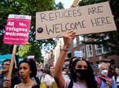 Protesters hold placards as they gather outside the Home Office in central London on 13 June to demonstrate against the UK Government’s intention to deport asylum-seekers to Rwanda (Photo: NIKLAS HALLE’N/AFP via Getty Images)