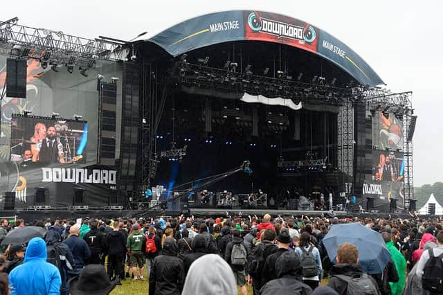People gather around the main stage during the hard rock music Download (Photo by BERTRAND GUAY/AFP via Getty Images)