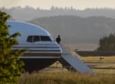 A man stands on the steps of the grounded Rwanda deportation flight EC-LZO Boeing 767 at Boscombe Down Air Base, on June 14, 2022 in Boscombe Down near Amesbury, Wiltshire, England