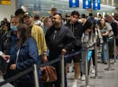 Travellers wait in a long queue to pass through the security check at Heathrow on June 1, 2022 in London, England. (Photo by Carl Court/Getty Images)