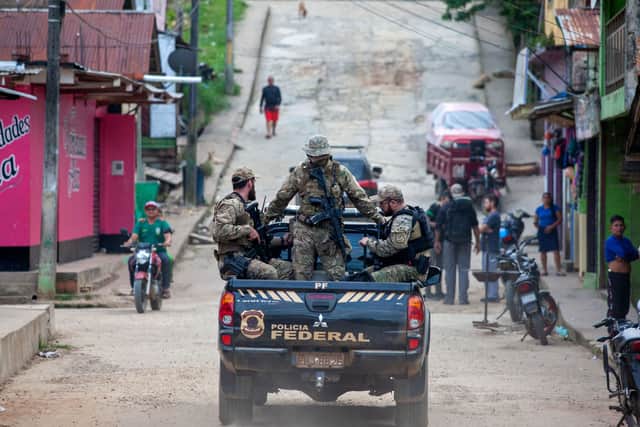 Experts from the Federal Police from the Task Force are taken on a pick-up truck upon arriving at the port of Atalaia do Norte (Pic: AFP via Getty Images)