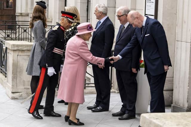 Queen Elizabeth II shakes hands with Lord Geidt on her arrival to visit Kings College in central London on March 19, 2019 (Photo by NIKLAS HALLE’N/AFP via Getty Images)