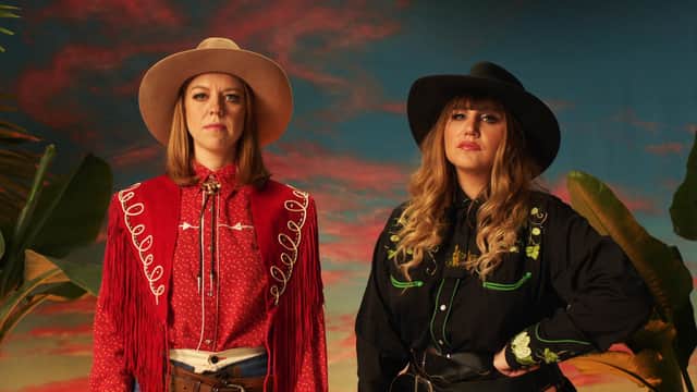 Ellie White and Natasia Demetriou, dressed as cowboys (Credit: BBC/Nit Television)